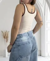 Musculosa beige con cuello redondo y ribetes en color marrón.