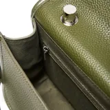 Bandolera de mano con textura granulada, color verde oliva. Cuenta con una solapa frontal con cierre metálico giratorio, asa superior rígida y correa larga ajustable y extraíble. Incluye el logo metálico de la marca en la parte frontal.