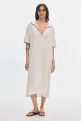 Vestido midi de punto calado color marfil, con cuello polo abierto y detalles de vivos en contraste de colores en el cuello y las mangas.