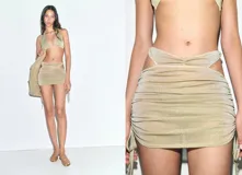 Minifalda de lúrex dorado con diseño fruncido en los laterales, detalles cut-out en la cintura y cierre de lazos ajustables. Colaboración Supriya Lele x Mango.
