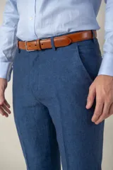 Pantalón de lino azul, de corte clásico y recto, con bolsillos laterales y trabillas para cinturón.