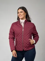 Campera azul marino capitoneada en nylon, manga larga, con entalle elástico en laterales, cierre frontal con cremallera dorada y cuello mao. Bolsillos frontales con tapa y broche. Detalle de presilla desmontable en el contorno de cuello.