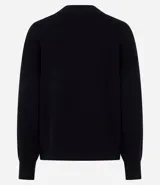 Buzo de tricot con cuello redondo y puños ajustados. Presenta un diseño de calce holgado y tejido de punto liso.