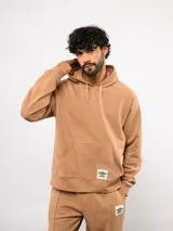 Canguro de felpa color camel con capucha ajustable, bolsillo canguro frontal y logo de Umbro en el pecho.