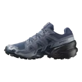 Calzado de trekking Salomon modelo Speedcross 6, en tonos gris y verde claro, diseñadas para trail running con suela de gran tracción y cordones de ajuste rápido.