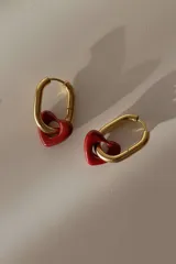 Aros tipo argolla de acero quirúrgico hipoalergénico, color dorado, con un dije colgante de corazón de cerámica roja.