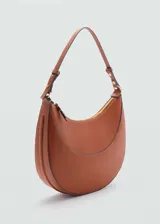 Bolso de hombro con diseño redondeado en forma de media luna, confeccionado en material sintético con acabado liso. Cuenta con cierre de cremallera superior, asa corta ajustable y forro interior.