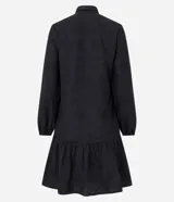 Vestido corto estilo camisa confeccionado en laise negro con bordado floral, cuello inglés, mangas largas abullonadas con puños elásticos y volado en el bajo. Cierre frontal con botones.