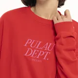 Buzo rojo de corte holgado con cuello redondo y estampado frontal con la inscripción "Pulau Dept. Since 2021" en color rosa.