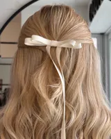 Par de hebillas para el pelo con moño de cinta de grogrén negro y tiras largas.