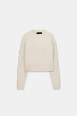 Jersey de punto de cuello redondo y manga larga, con acabado en rib en puños y ruedo.