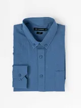 Camisa de manga larga con efecto lino, color azul, cuello con botones y bolsillo ojal en el pecho.