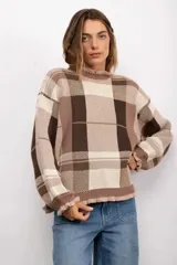 Sweater de punto con diseño de cuadros en tonos beige y marrón, cuello redondo con detalle de volados, mangas largas abullonadas y puños con volados.