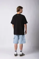 Remera de corte oversize color negro, con cuello redondo y estampa minimalista con la palabra 'HUMAN' en el pecho.