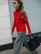 Polera de cuello alto confeccionada en tejido de punto fino, con mangas largas y detalle de tajo en los puños.