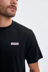 Remera negra de manga corta con estampa gráfica de la máscara de Spiderman en color blanco en la espalda y pequeño logo en rojo.