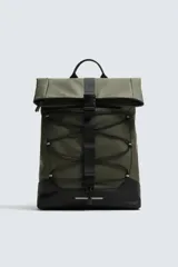 Mochila técnica de acabado engomado en color verde oliva con base negra. Cuenta con cierre de solapa con hebilla, cordones elásticos frontales decorativos, bolsillo plano frontal, compartimento interior para dispositivos electrónicos y espalda acolchada con banda para equipaje.