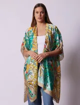 Kimono de satén con estampado tropical y hojas en tonos verdes, amarillos y naranjas sobre fondo claro. Tiene mangas anchas y corte abierto.
