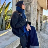 Bufanda de lana color azul marino con flecos en los extremos.