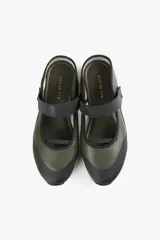 Zapato de diseño urbano color blanco con detalles en negro y amarillo, suela dentada y tira de velcro en el empeine.