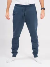 Pantalón babucha deportivo unisex azul, de tiro alto, con puños y cordones ajustables.