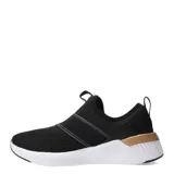 Championes Puma modelo Softride Harli Slip On, de diseño sin cordones con bandas elásticas cruzadas en el empeine. Confeccionados en tejido de malla transpirable color negro, cuentan con entresuela blanca con tecnología de amortiguación y detalles en color cobre, incluyendo el logo de la marca.