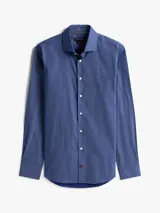 Camisa de manga larga Tommy Hilfiger con corte slim, confeccionada en algodón. Presenta un estampado de micro puntos en tonos azules y blancos, cuello clásico y cierre frontal con botones. Incluye el logo de la marca bordado en el pecho.