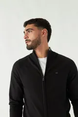 Campera tejida color verde militar, con cuello alto, puños y logo bordado.