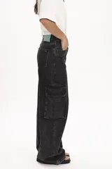 Pantalón de jean negro con efecto lavado, corte ancho, tiro alto y bolsillos cargo laterales.