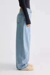 Jean balloon de tiro alto, confeccionado en denim rígido color celeste, con costuras verticales expuestas en el frente y perneras amplias.