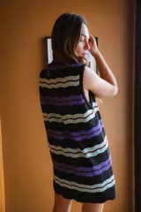 Vestido de tejido fino con calado, de manga corta y botones teñidos a tono. Diseño a rayas horizontales en blanco, rojo y marrón oscuro.