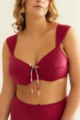 Soutien de baño color borgoña con aro, breteles anchos regulables, nudo en la espalda y detalle de moño estampado.