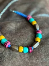 Collar corto con cuentas de madera, acrílico y cristales en tonos turquesa, amarillo, marrón y fucsia.