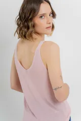 Musculosa tejida color amarillo pálido, con escote en V delantero y trasero.