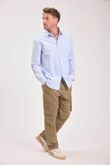 Camisa blanca de manga larga con cuello clásico y cierre frontal con botones.