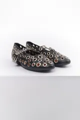 Ballerinas negras de cuero sintético con correa sobre el empeine y hebilla metálica. Diseño con múltiples ojalillos metálicos.