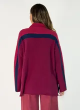 Sweater de punto con diseño de bloques de color en tonos marrón, chocolate y bordó, de cuello alto y corte holgado.