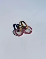 Aros tipo argolla dorados con dije circular de resina transparente y strass color fucsia.