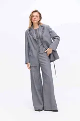 Blazer gris a rayas con solapa de volados, manga larga y lazo ajustable en la cintura.