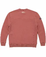 Buzo de algodón color terracota, con corte oversize, cuello redondo y puños acanalados. Presenta un pequeño estampado tipográfico en el centro del pecho y un parche con logo en la manga derecha.