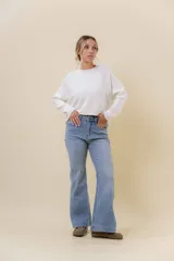Jean wide leg de tiro alto con pierna amplia, confeccionado en denim con leve desgaste. Presenta cintura con presillas, bolsillos clásicos y cierre frontal con botón.