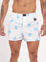 Bóxer de algodón blanco con estampado de flores pequeñas color celeste, con cintura elástica y logo de la marca en el centro.