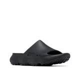Sandalia tipo slide Columbia modelo Thrive Revive, color negro, diseñada para recuperación con entresuela de espuma ligera y suave. Presenta aberturas laterales para ventilación, plantilla hexagonal texturizada y suela de alta tracción para condiciones húmedas y secas.