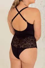 Body negro de lycra y puntilla elastizada, con tiras cruzadas en el frente, breteles regulables y broche en la entrepierna.