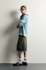 Jersey de punto de corte relaxed fit confeccionado en hilatura de algodón, con cuello redondo y manga larga. Presenta un diseño de efecto lavado con costuras en contraste y acabados en rib.
