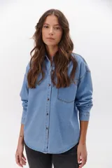 Camisa de jean celeste con botones metálicos envejecidos, manga larga y bolsillo en el pecho.