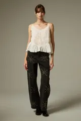 Musculosa de algodón color blanco con breteles finos, diseño plisado, detalles de encaje y cuello en V profundo.