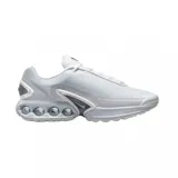 Championes Nike Air Max Dn de diseño moderno en color blanco. Presentan una parte superior de malla técnica transpirable y una unidad de amortiguación Air Max visible en el talón con cuatro cámaras de aire circulares. Incluyen detalles en gris claro y un pequeño logo de la marca en el lateral.