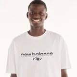 Remera New Balance Trackside de algodón, color blanco, de corte cuadrado y relajado, con cuello redondo y mangas cortas. Presenta estampado frontal en relieve con el logotipo de la marca.