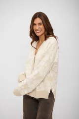Saco tipo cardigan de punto con diseño floral en relieve, cuello en V y cierre frontal con botones. Presenta puños y ruedo acanalados.